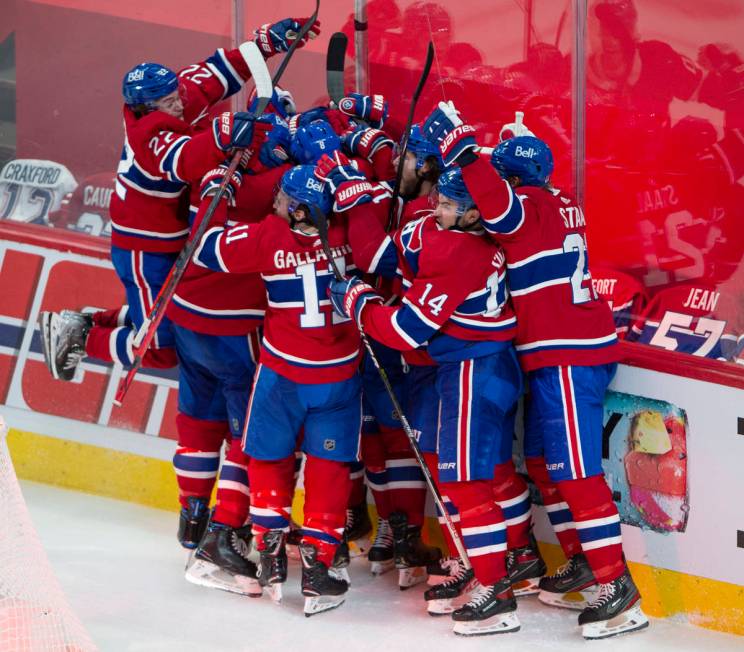 Montreal Canadiens players celebrate after defeating the Vegas Golden Knights following overtim ...