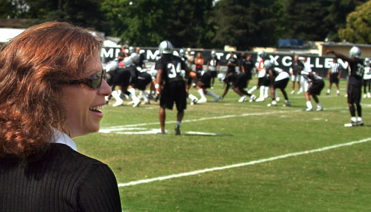 Amy Trask, Chief Executive of the Oakland Raiders, watches the team and talks with fans and com ...