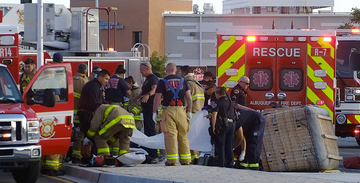 Albuquerque Fire Rescue crews work on victims of the fatal balloon crash at Unser and Central S ...