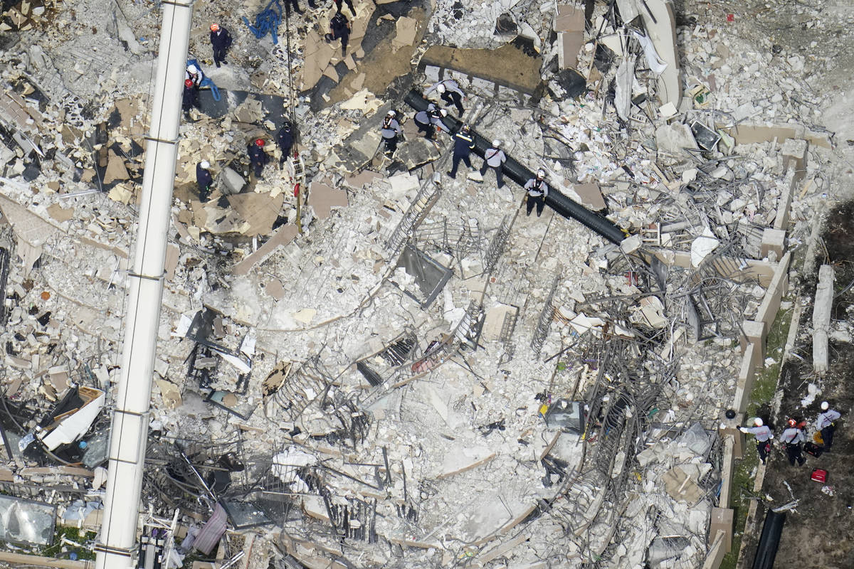 Workers search in the rubble at the Champlain Towers South Condo, Saturday, June 26, 2021, in S ...