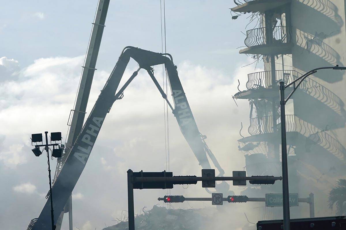 A crane works at the site of the Champlain Towers South Condo building, Saturday, June 26, 2021 ...