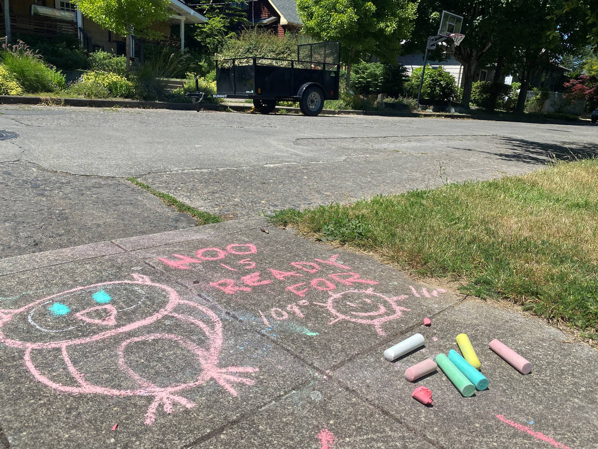 A chalk drawing on the sidewalk in a residential neighborhood in Southeast Portland, Ore., Frid ...
