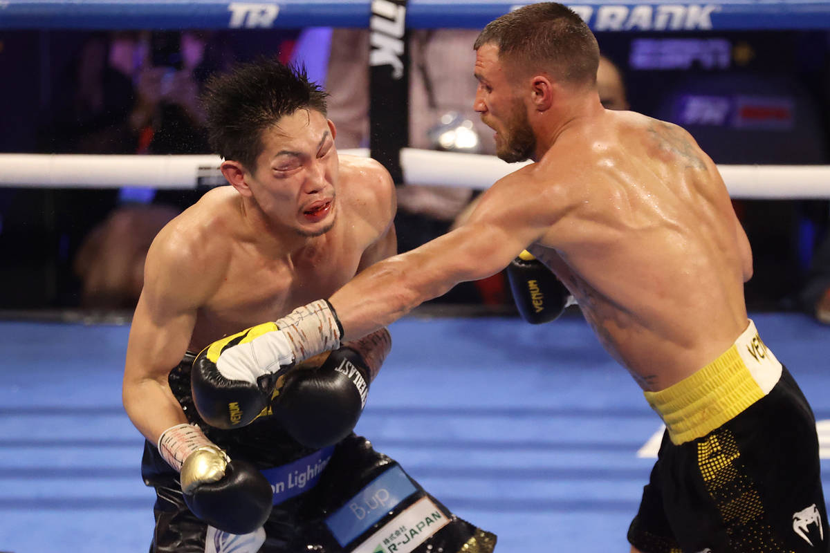 Vasyl Lomachenko, right, connects a punch against Masayoshi Nakatani in the ninth round of the ...