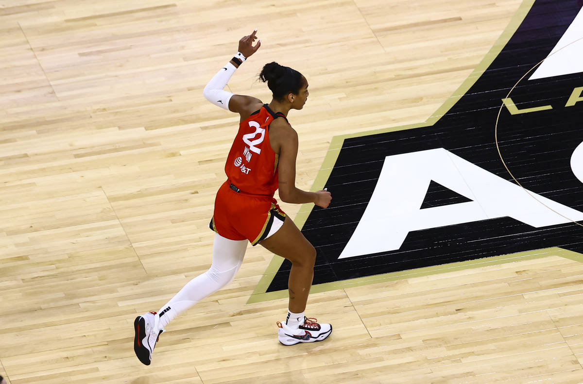 Las Vegas Aces' A'ja Wilson (22) celebrates after scoring against Seattle Storm during the firs ...