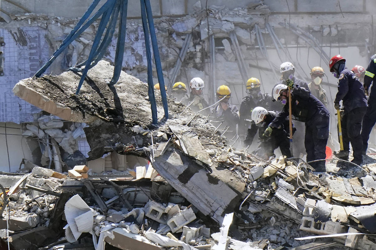 Crews work in the rubble at the Champlain Towers South Condo, Sunday, June 27, 2021, in Surfsid ...