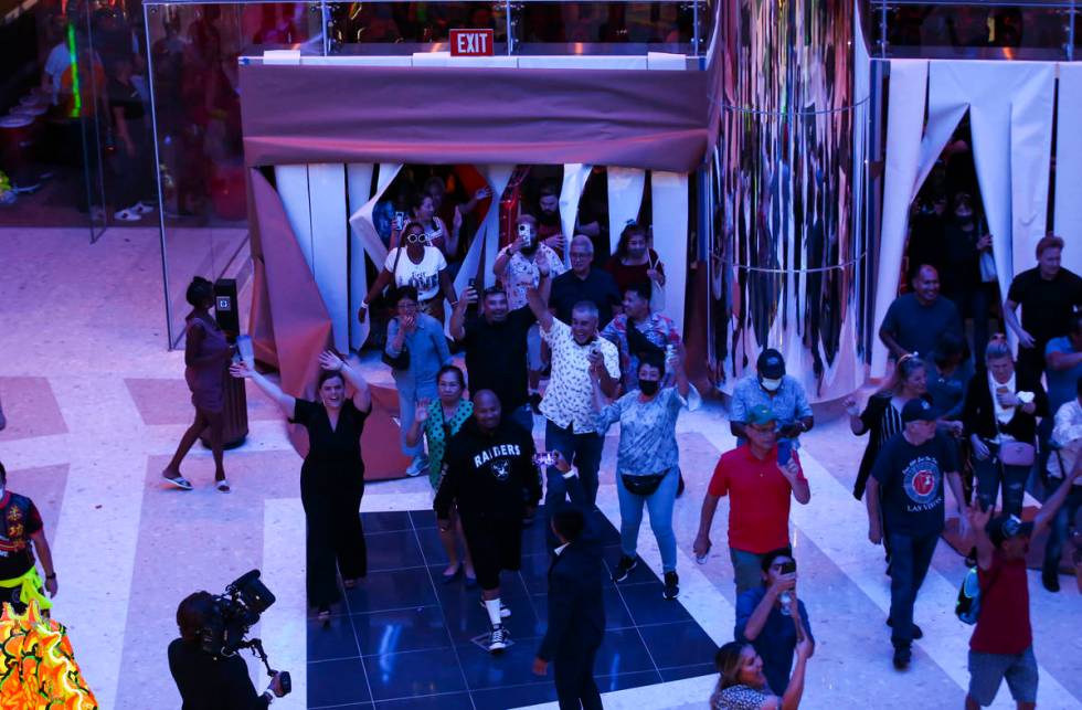 People walk into The District as the doors open to the public at Resorts World Las Vegas on Thu ...