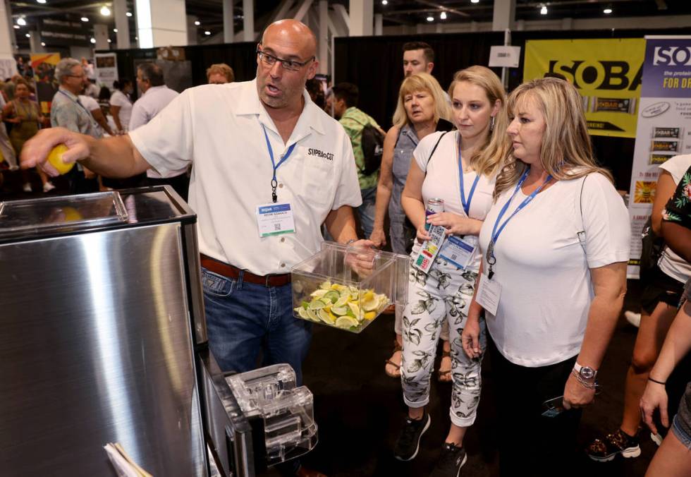 Kevin Szakacs of Las Vegas demonstrates his automatic slicer to Janine Andrews, right, and Kait ...