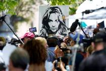 A portrait of Britney Spears looms over supporters and media members outside a court hearing co ...