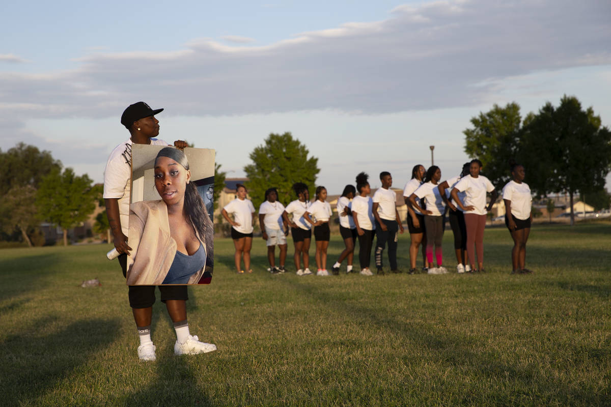 Chalonge Hodge holds a photo of her neice, 18-year-old Shania James, who was shot and killed in ...