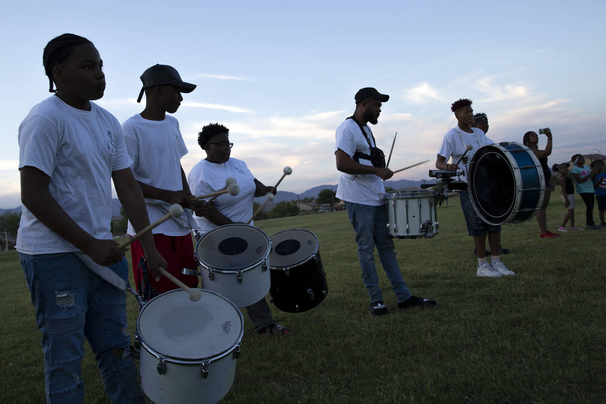 Members of Superior Squad drill and drum squad perform at a vigil for their late teammate, 18-y ...