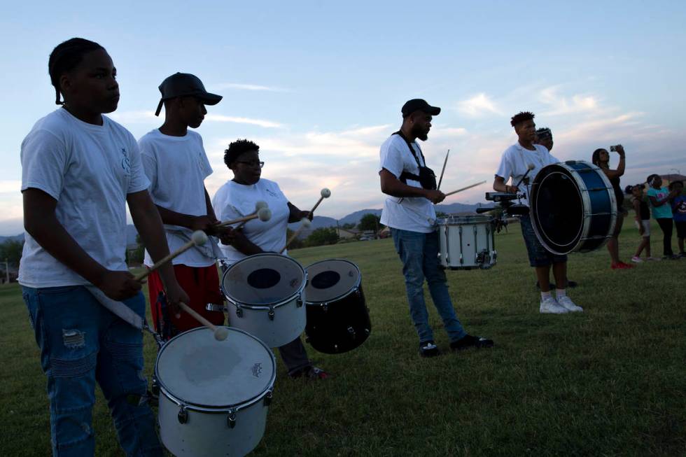 Members of Superior Squad drill and drum squad perform at a vigil for their late teammate, 18-y ...