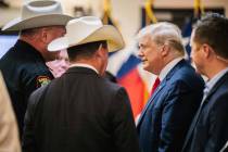 Former President Donald Trump greets law enforcement while arriving at a border security briefi ...