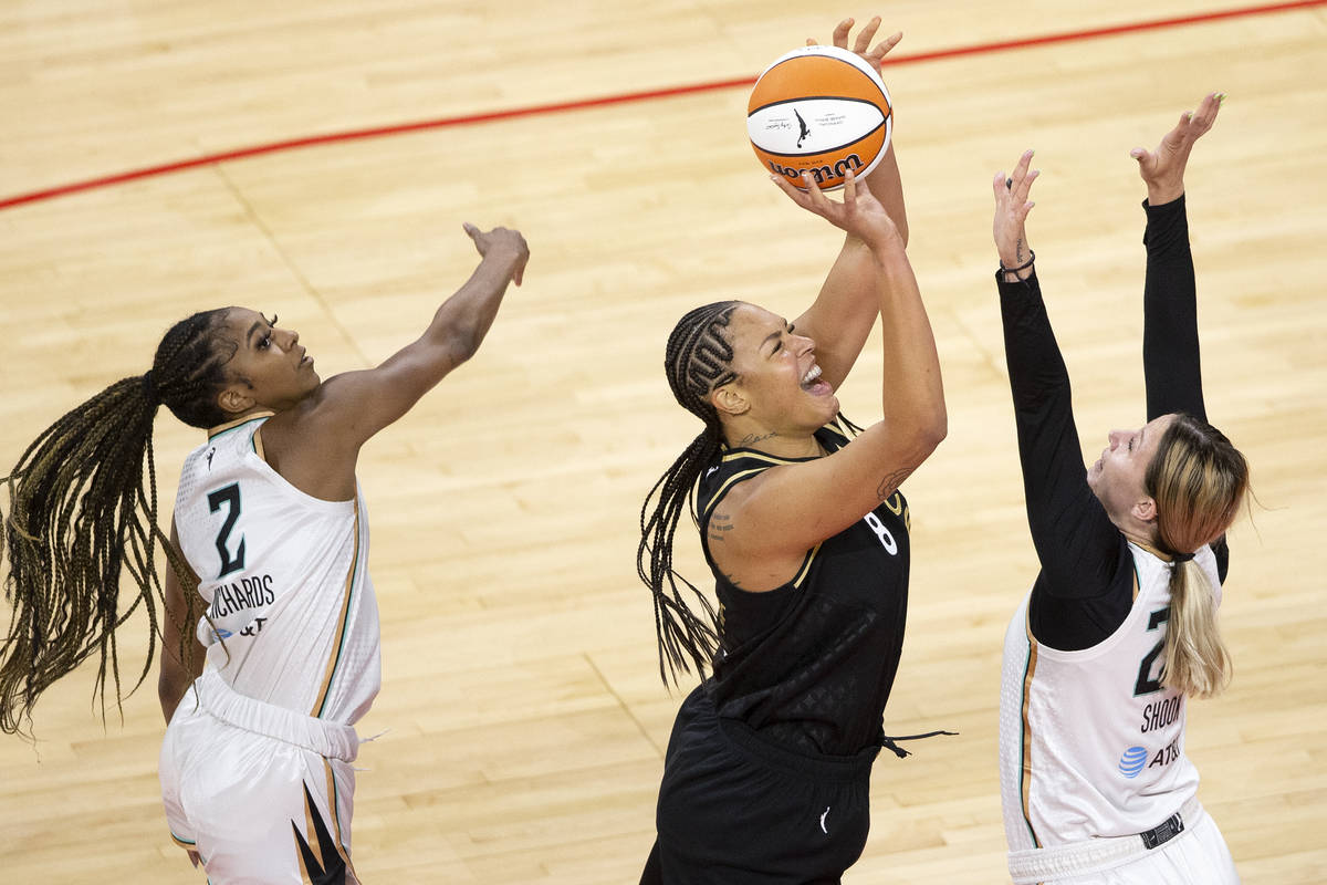 New York Liberty's DiDi Richards (2) and forward Kylee Shook defend against Las Vegas Aces cent ...