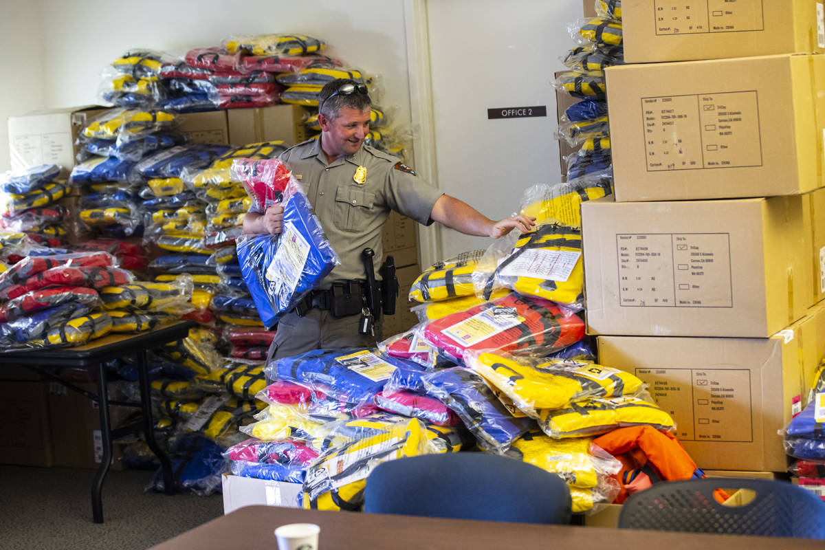 Matt Stark, deputy chief ranger at Lake Mead, helps organize lifejackets that were delivered to ...