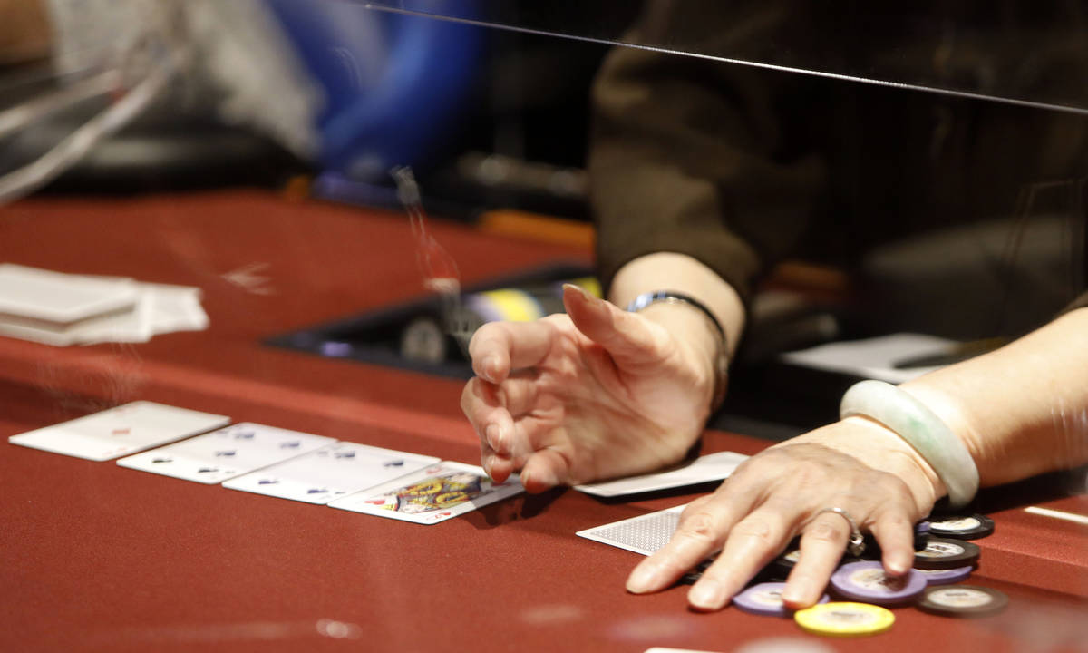 A dealer handles chips in $175 No-Limit Hold'em Ladies tournament during 2021 Nevada State Ladi ...