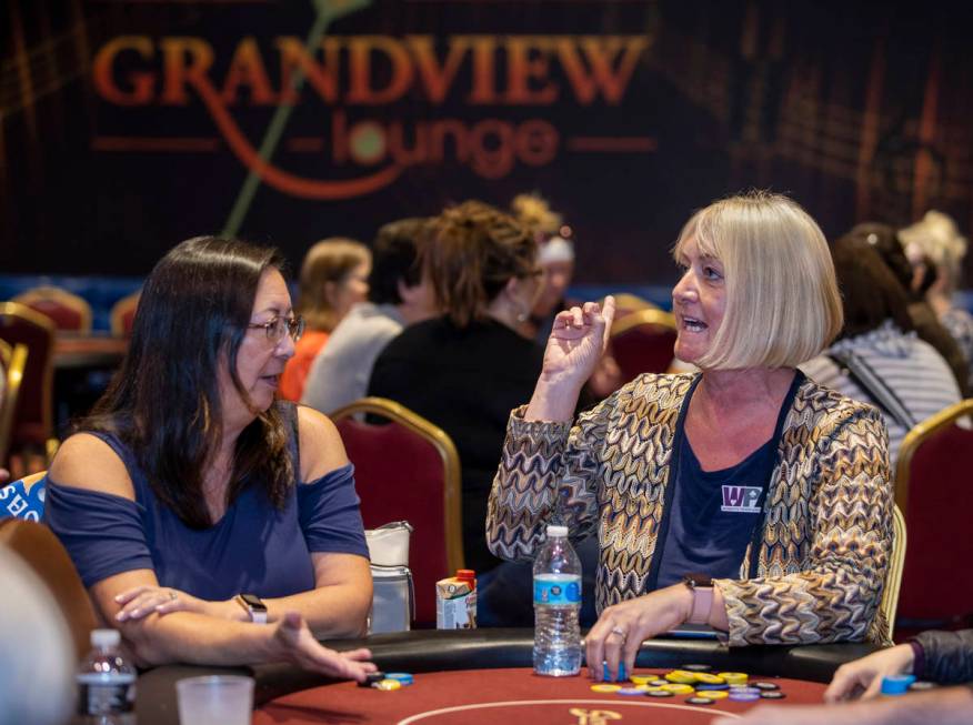 Players Julie Herbert , left, and Vera Murillo talk in between hands as they compete in the $35 ...