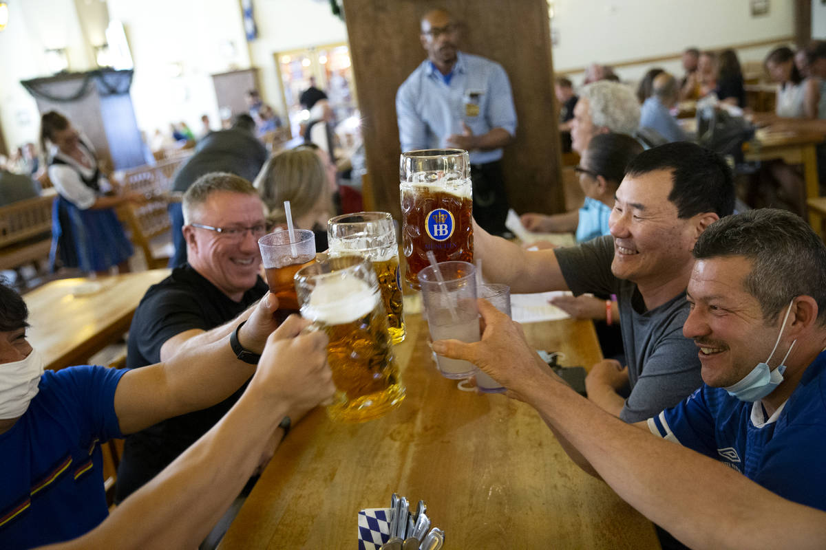 Diners at Hofbrauhaus cheers their beers on Thursday, June 17, 2021, in Las Vegas. The restaura ...