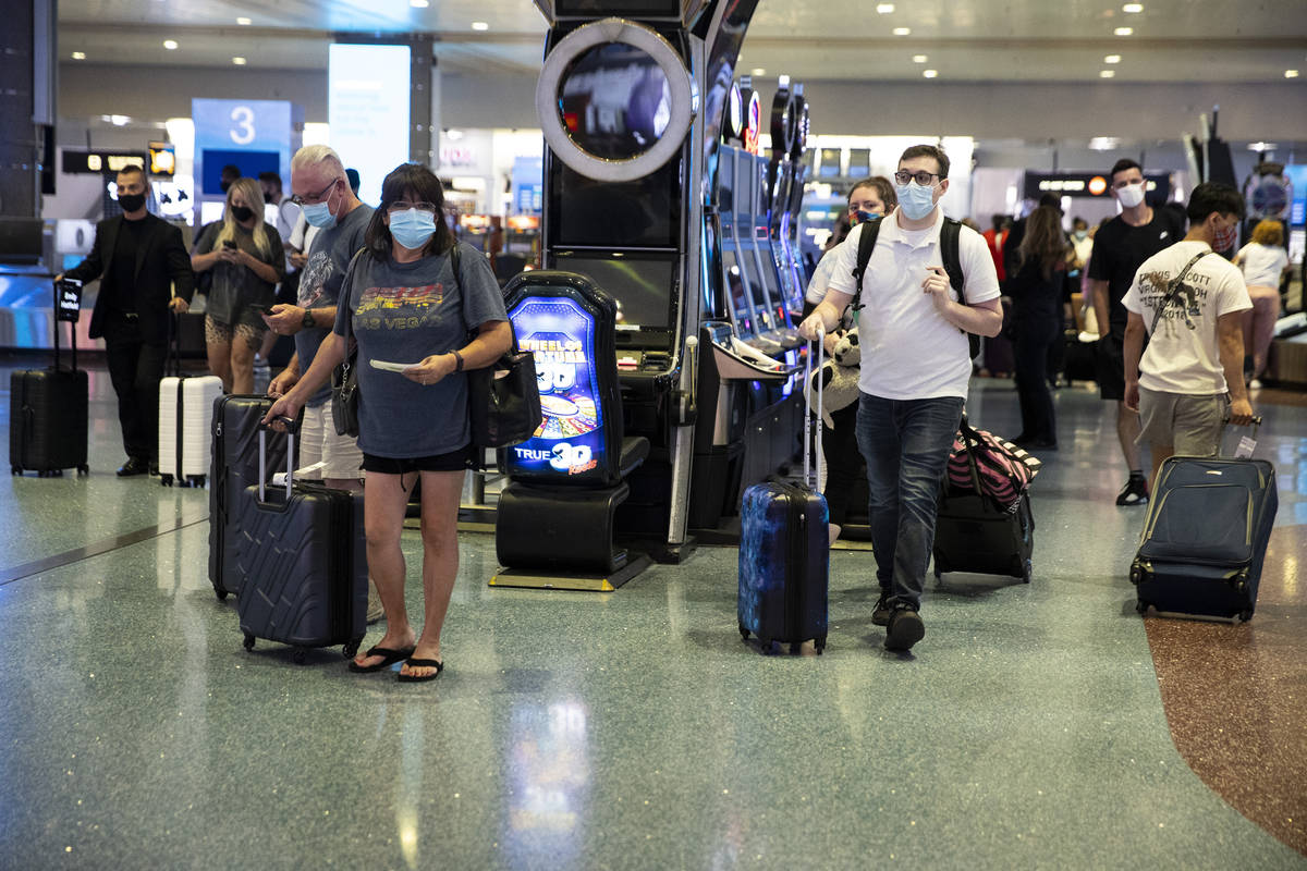 People arrive at McCarran International Airport Terminal 1 in Las Vegas, Friday, July 2, 2021. ...