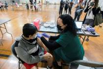 Nurse Jessica Lipscomb gives Miguel Castro, 13, of Brentwood, the Pfizer COVID-19 vaccine in th ...