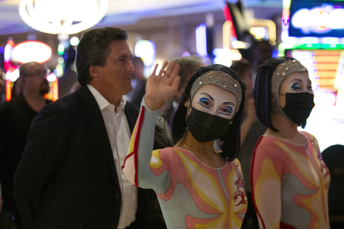 MGM Resorts International CEO Bill Hornbuckle walks behind a pair of "O" performers a ...