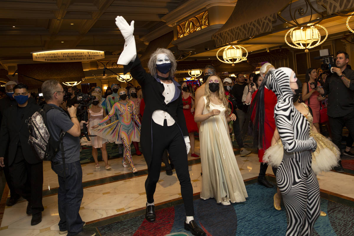 Cast members of "O" walk through Bellagio in a welcome back parade on Thursday, July ...