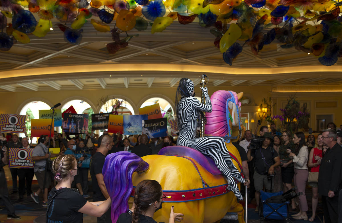 Cast members of "O" are greeted in the Bellagio lobby during a welcome back parade on ...