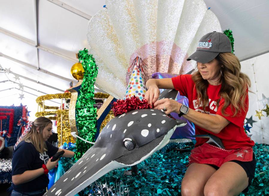 Jordyn Doyle, left, and Elizabeth Engle, volunteers, decorate "Undersea Jubilee" float for the ...