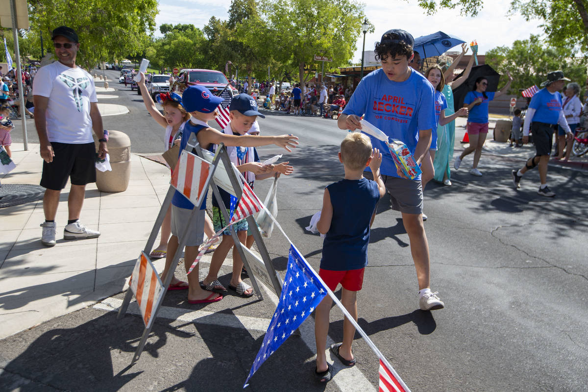 A marcher hands out popsicles to children in the crowd during the two-day Damboree event on Sat ...