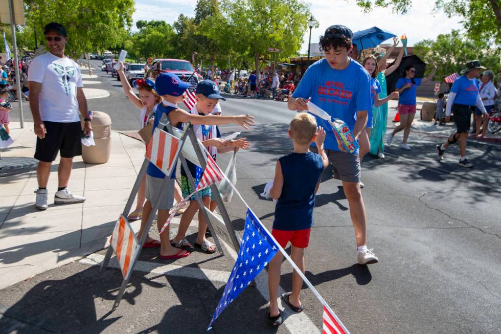 A marcher hands out popsicles to children in the crowd during the two-day Damboree event on Sat ...