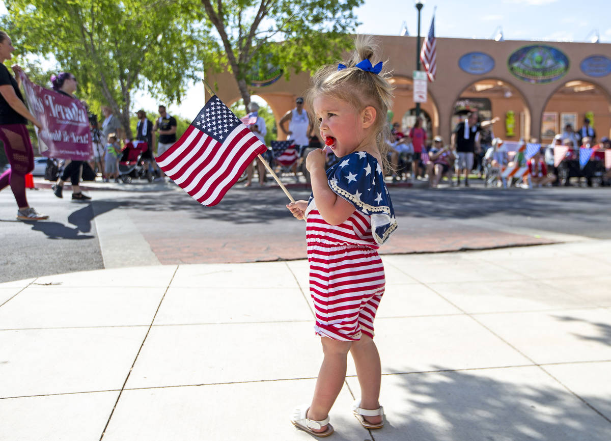 Olivia Ruecking enjoys a treat as the parade passes down Nevada Way during the two-day Damboree ...