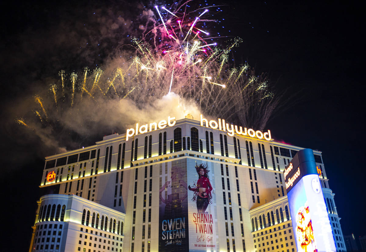Fireworks go off along the Las Vegas Strip as people watch from the Boulevard Pool at The Cosmo ...