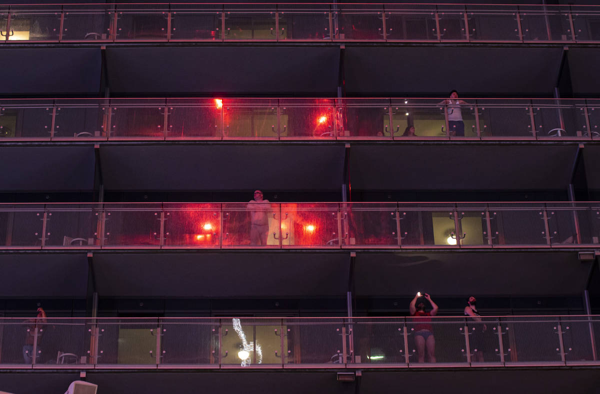 Fireworks are reflected in the balconies as people watch from The Cosmopolitan of Las Vegas on ...