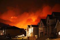 A wildfire on Traverse Mountain threatens homes on June 28, 2020, in Lehi, Utah. Officials said ...