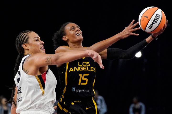 Los Angeles Sparks guard Brittney Sykes, right, shoots as Las Vegas Aces center Liz Cambage def ...