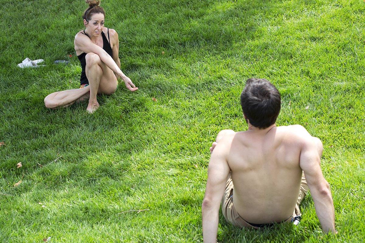 Natalie Kleinman, left, and Tyler Bryce, right, practice yoga despite an excessive heat warning ...