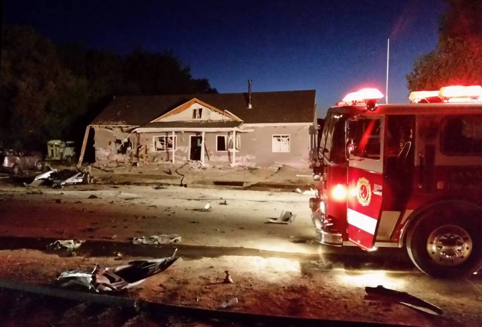 A fire truck sits in front of a house destroyed by a suicide bomb attack in Panaca on July 13, ...