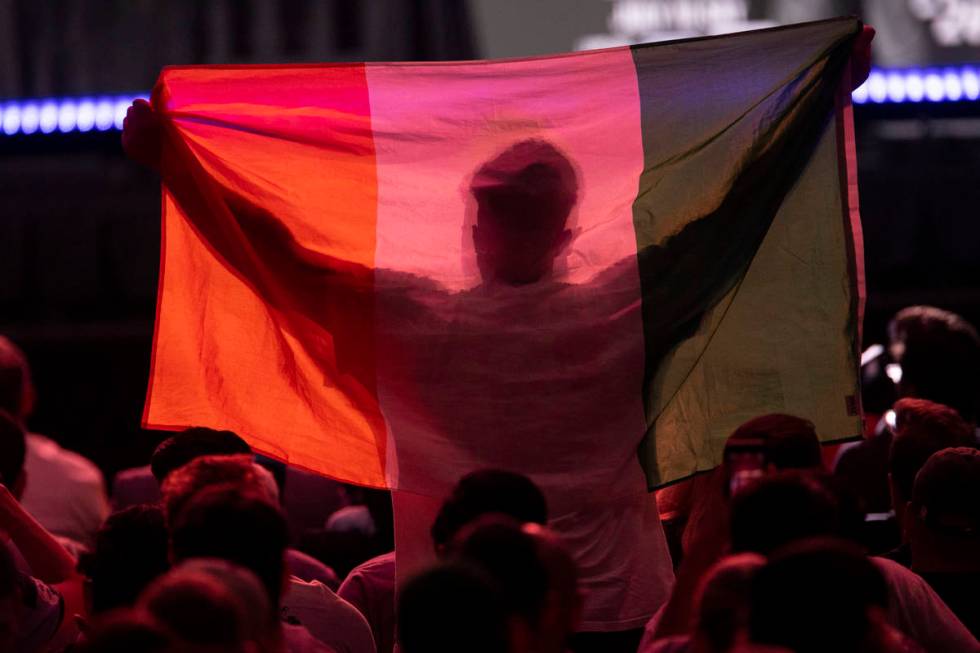 A fan raises an Ireland flag during an UFC 264 press conference at T-Mobile Arena in Las Vegas, ...