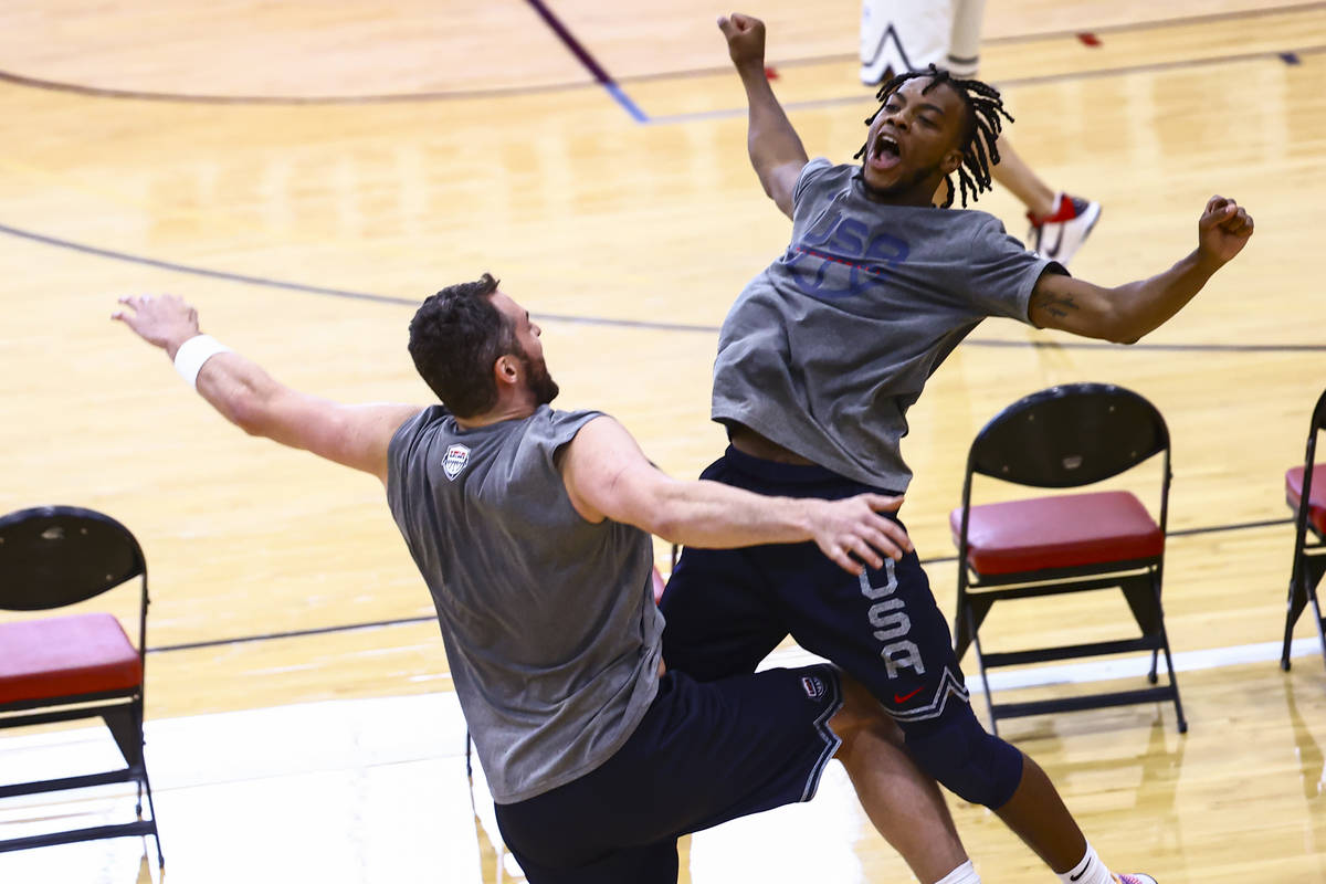 Kevin Love, left, and Darius Garland celebrate after taking turns shooting during USA Basketbal ...