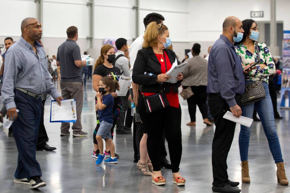 Job-seekers wait in line for the MGM Resorts International booth at a summer job fair hosted by ...