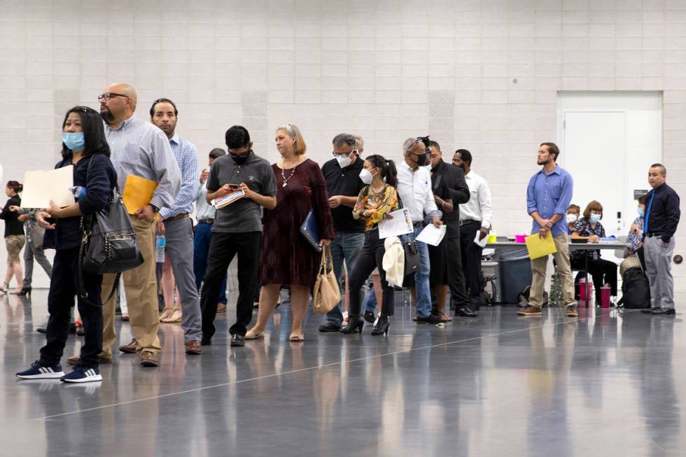 Job-seekers wait in line for the Amazon booth during a summer job fair hosted by Clark County a ...