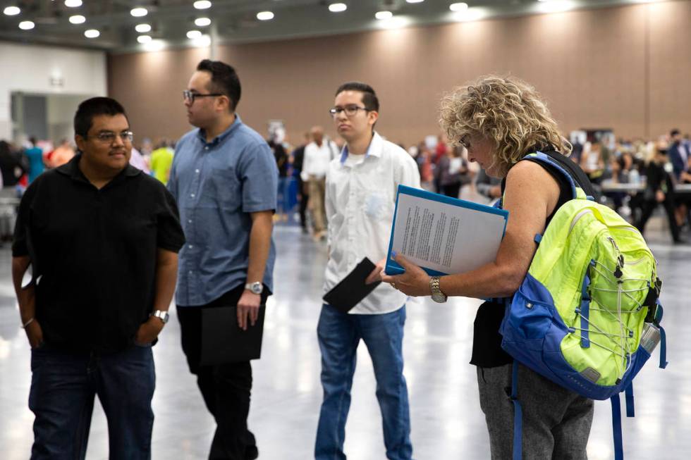 Joan Pashley-Baynes, right, reviews her resume during a summer job fair hosted by Clark County ...