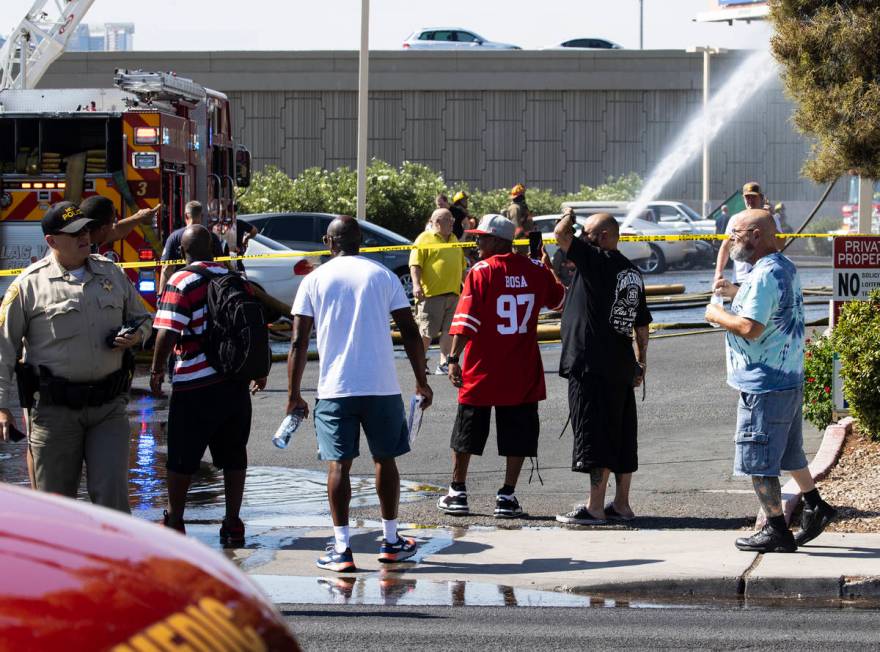 Residents at Bonanza Park Studios watch as Las Vegas firefighters battle a fire on 2221 Bonanza ...