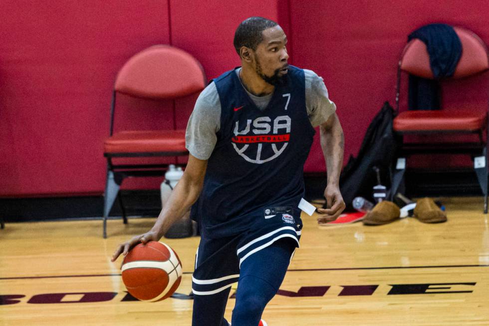 Kevin Durant (7) drives the ball around Kevin Love (11) during the first day of USA Basketball ...