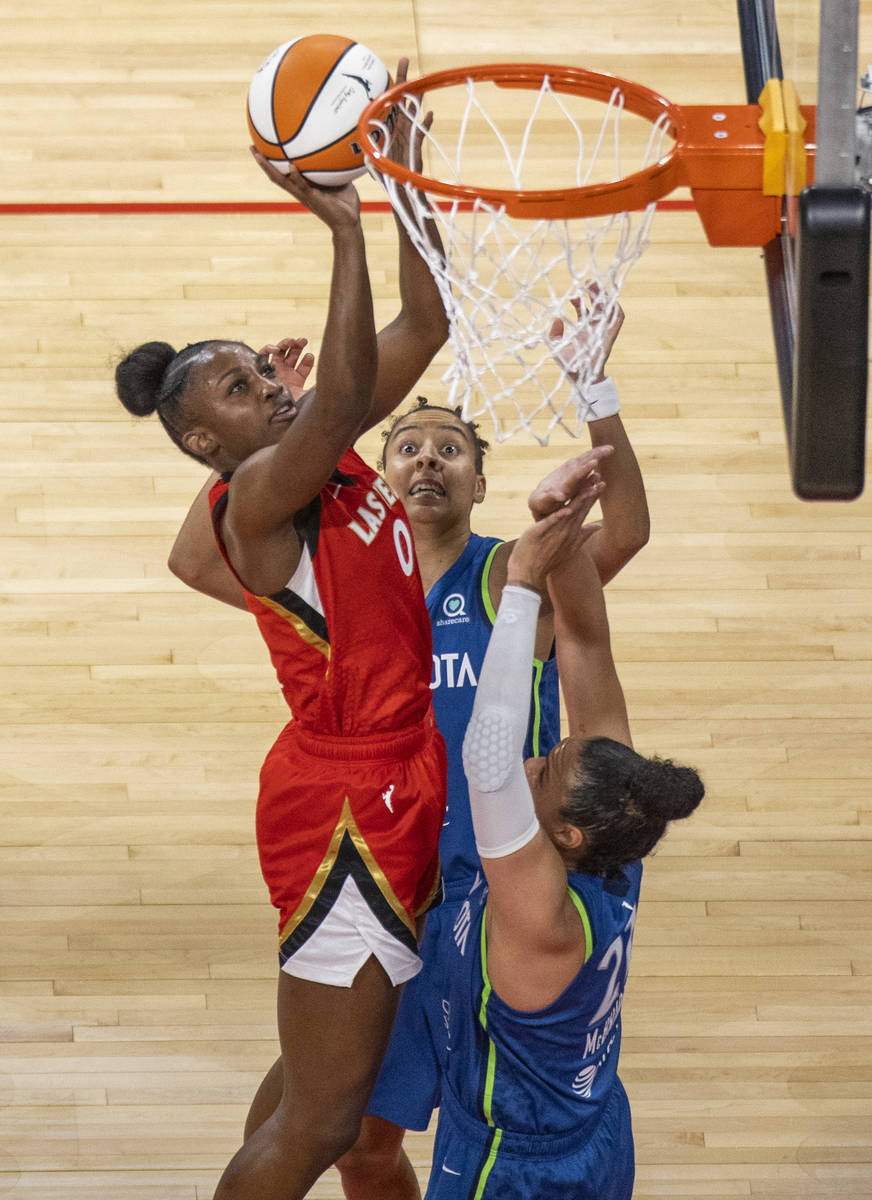 Las Vegas Aces guard Jackie Young (0) goes up to the rim for a basket over Minnesota Lynx forwa ...