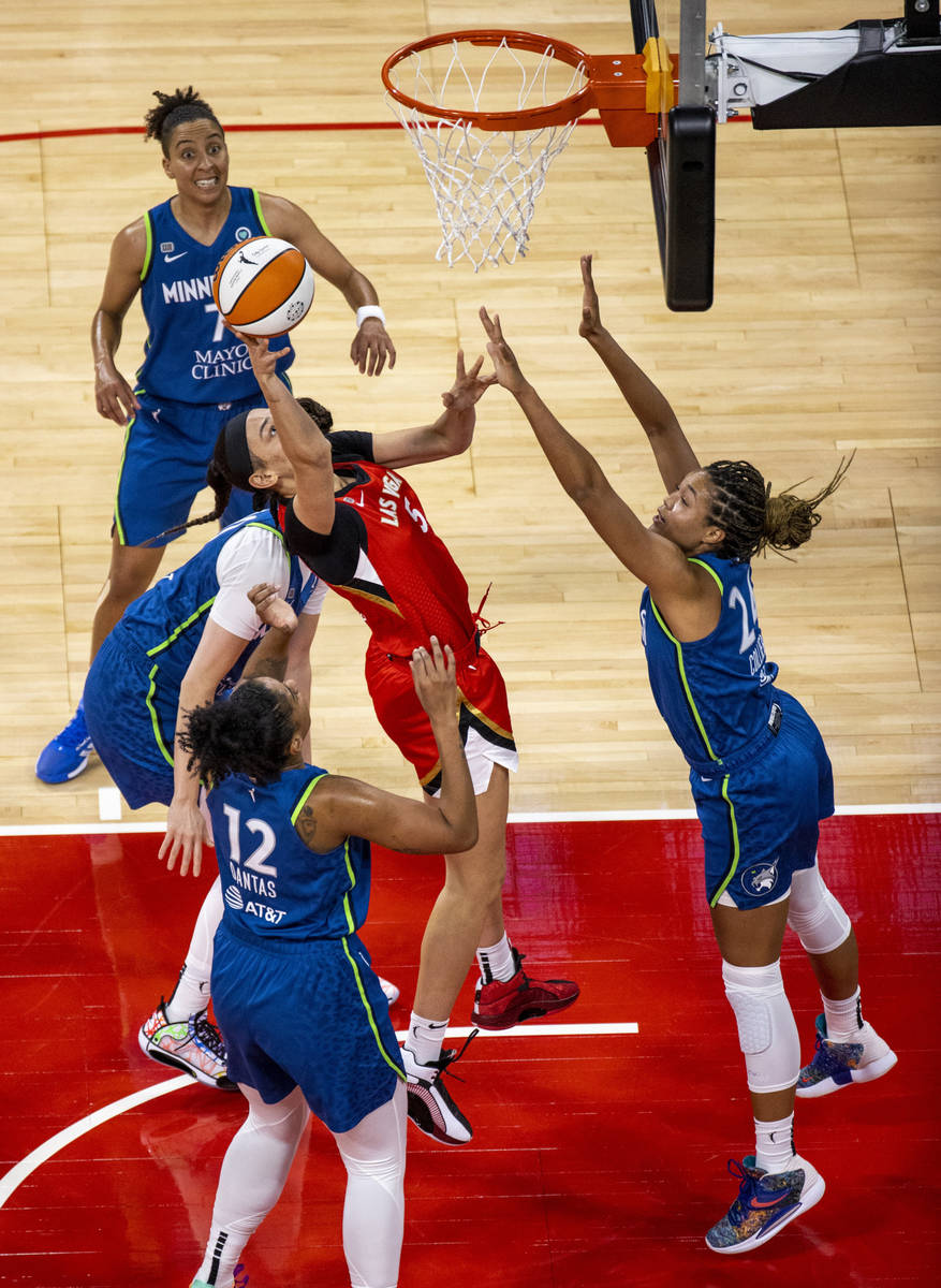 Las Vegas Aces forward Dearica Hamby (5) gets off a shot about four Minnesota players during th ...