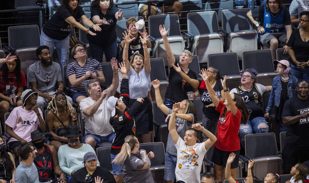 Las Vegas Aces fans reach for a t-shirt during a timeout versus the Minnesota Lynx during the f ...