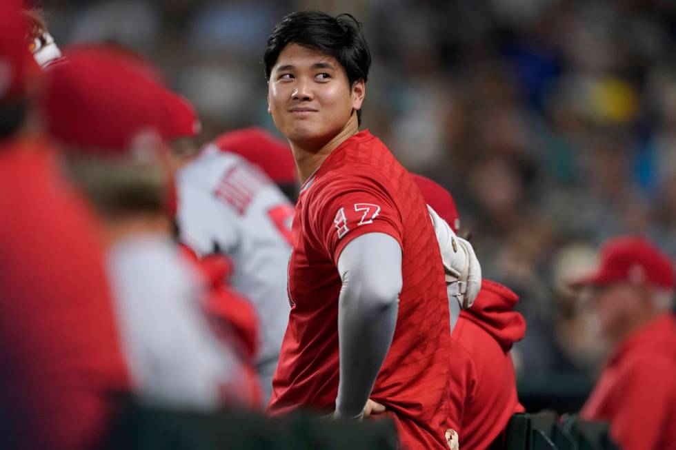 Los Angeles Angels' Shohei Ohtani looks out from the dugout during the sixth inning of the team ...