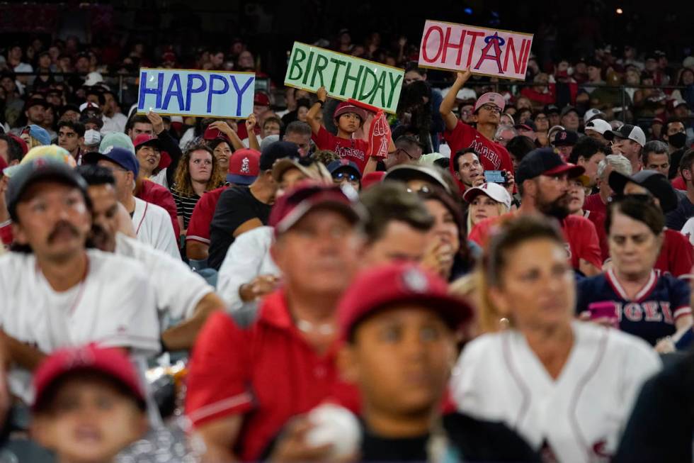 Fans hold up a sign for Los Angeles Angels designated hitter Shohei Ohtani's (17) birthday duri ...