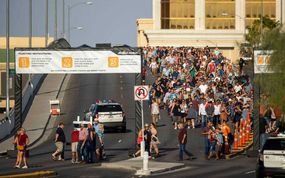 Fans make their way across the Hacienda overpass in the heat to the Garth Brooks concert at All ...