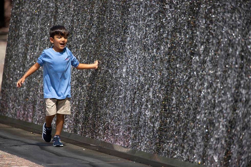 Ian Alaniz, 5, of Dublin, Texas, touches a water feature outside of New York-New York Hotel-Cas ...